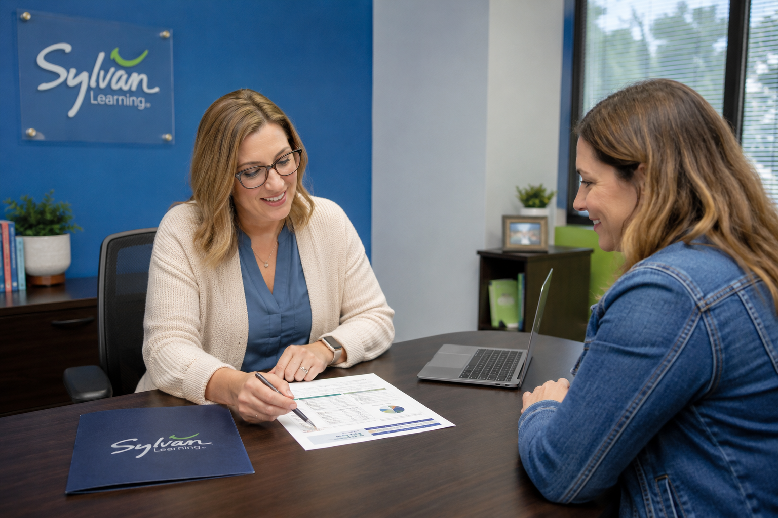 Center director reviewing a student’s assessment and learning plan with a parent